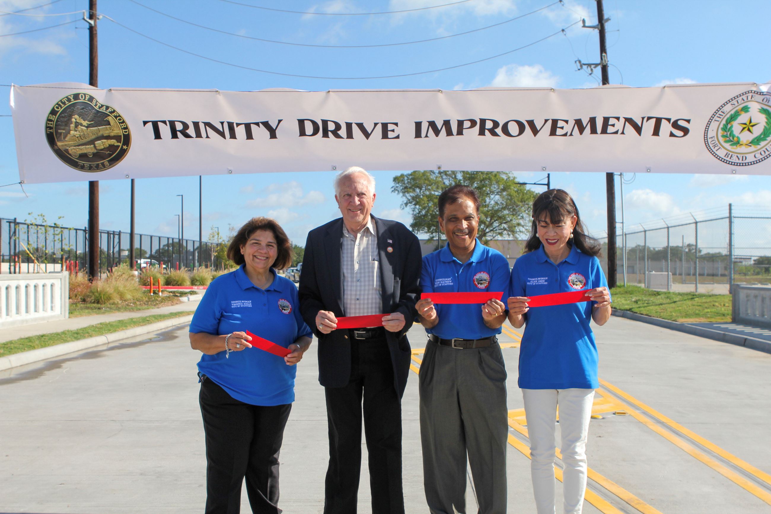 Mayor and city council in front of sign